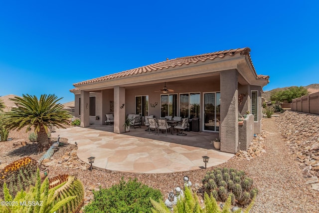 5371 W Leatherflower Ln, Marana, AZ 85658 - back of house featuring ceiling fan, stucco siding, and a tiled roof