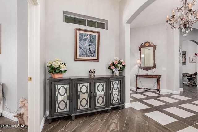 5371 W Leatherflower Ln, Marana, AZ 85658 - entryway with arched walkways, a chandelier, and dark wood-style floors
