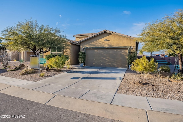 1123 E Lumberjack Trl, Sahuarita, AZ 85629 - view of front of home with stucco siding, a garage, concrete driveway, and a tiled roof