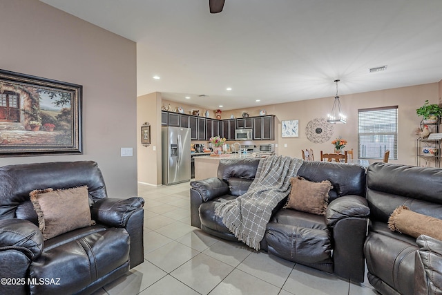 1123 E Lumberjack Trl, Sahuarita, AZ 85629 - living room featuring light tile patterned flooring, a chandelier, and recessed lighting