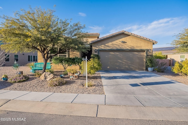1123 E Lumberjack Trl, Sahuarita, AZ 85629 - view of front of house featuring concrete driveway, stucco siding, a garage, and a tiled roof