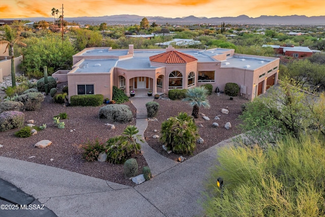 6265 N Jochums Dr, Tucson, AZ 85718 - view of front of house featuring a mountain view, stucco siding, covered porch, and a chimney