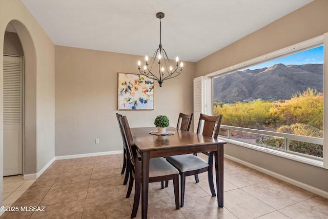 6265 N Jochums Dr, Tucson, AZ 85718 - dining space featuring plenty of natural light, a mountain view, a chandelier, and light tile patterned floors