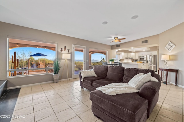 6265 N Jochums Dr, Tucson, AZ 85718 - living area featuring light tile patterned floors, ceiling fan, and vaulted ceiling