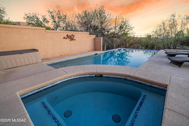 6265 N Jochums Dr, Tucson, AZ 85718 - pool at dusk featuring an in-ground hot tub