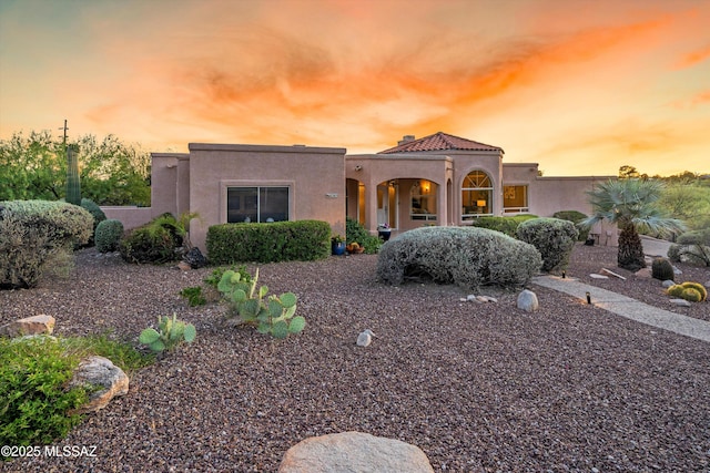 6265 N Jochums Dr, Tucson, AZ 85718 - mediterranean / spanish-style home with stucco siding, a chimney, and a tile roof