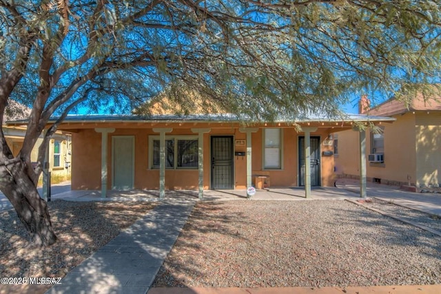 815 E 8th St, Tucson, AZ 85719 - ranch-style house featuring stucco siding, a porch, and cooling unit