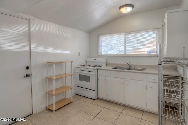 815 E 8th St, Tucson, AZ 85719 - kitchen with gas range gas stove, lofted ceiling, white cabinets, light tile patterned flooring, and plenty of natural light