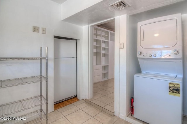 815 E 8th St, Tucson, AZ 85719 - washroom with stacked washer and clothes dryer and light tile patterned floors