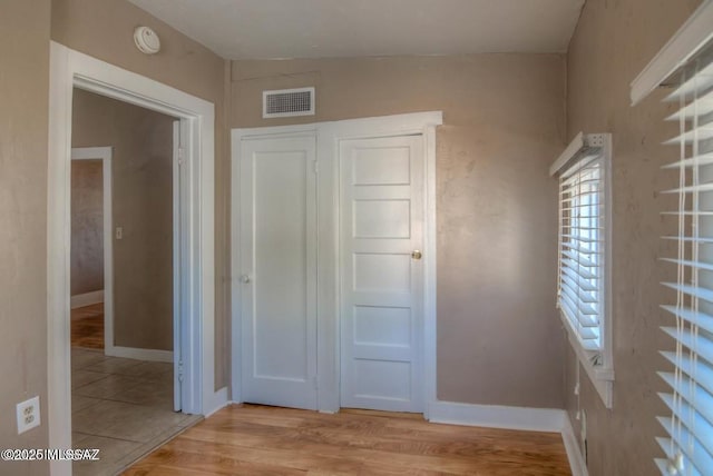815 E 8th St, Tucson, AZ 85719 - unfurnished bedroom featuring wood finished floors and baseboards