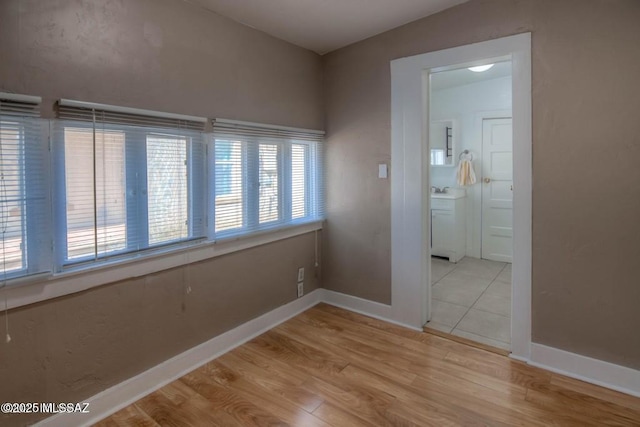 815 E 8th St, Tucson, AZ 85719 - empty room with baseboards and light wood-style flooring
