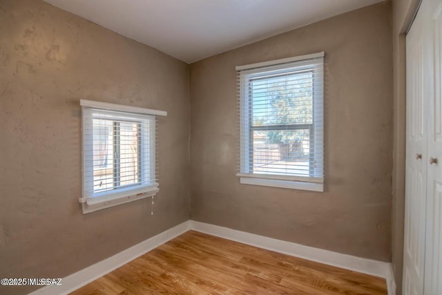 815 E 8th St, Tucson, AZ 85719 - empty room with plenty of natural light and light wood-style flooring