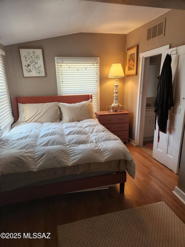 815 E 8th St, Tucson, AZ 85719 - bedroom featuring light wood finished floors, lofted ceiling, and connected bathroom