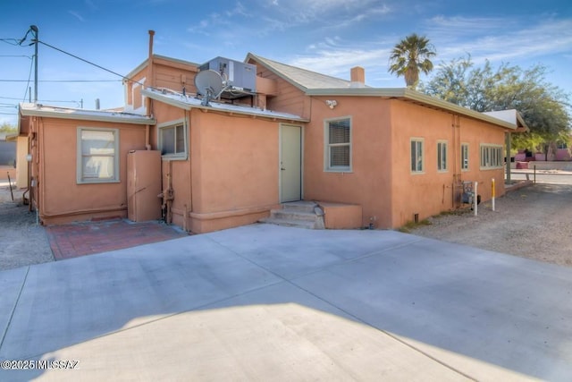 815 E 8th St, Tucson, AZ 85719 - back of property featuring stucco siding, a patio, and a chimney