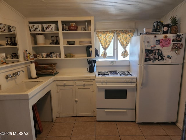 815 E 8th St, Tucson, AZ 85719 - kitchen with white appliances, light countertops, light tile patterned floors, white cabinets, and ornamental molding