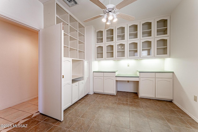 4823 S View Ridge Dr, Green Valley, AZ 85622 - unfurnished office featuring built in study area, ceiling fan, and light tile patterned flooring