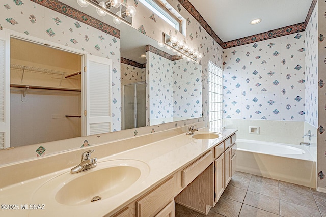 4823 S View Ridge Dr, Green Valley, AZ 85622 - full bath featuring wallpapered walls, a stall shower, a garden tub, double vanity, and a spacious closet