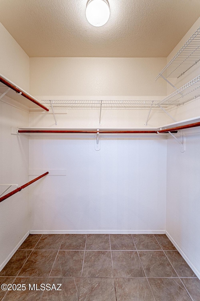 4823 S View Ridge Dr, Green Valley, AZ 85622 - walk in closet featuring tile patterned flooring