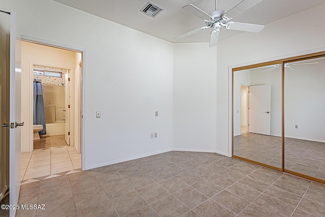 4823 S View Ridge Dr, Green Valley, AZ 85622 - unfurnished bedroom featuring a closet, tile patterned flooring, ceiling fan, and ensuite bathroom