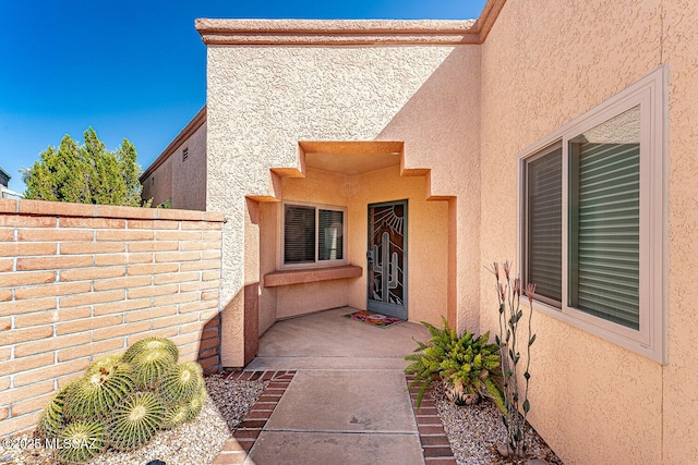 4823 S View Ridge Dr, Green Valley, AZ 85622 - view of exterior entry with stucco siding and a patio area