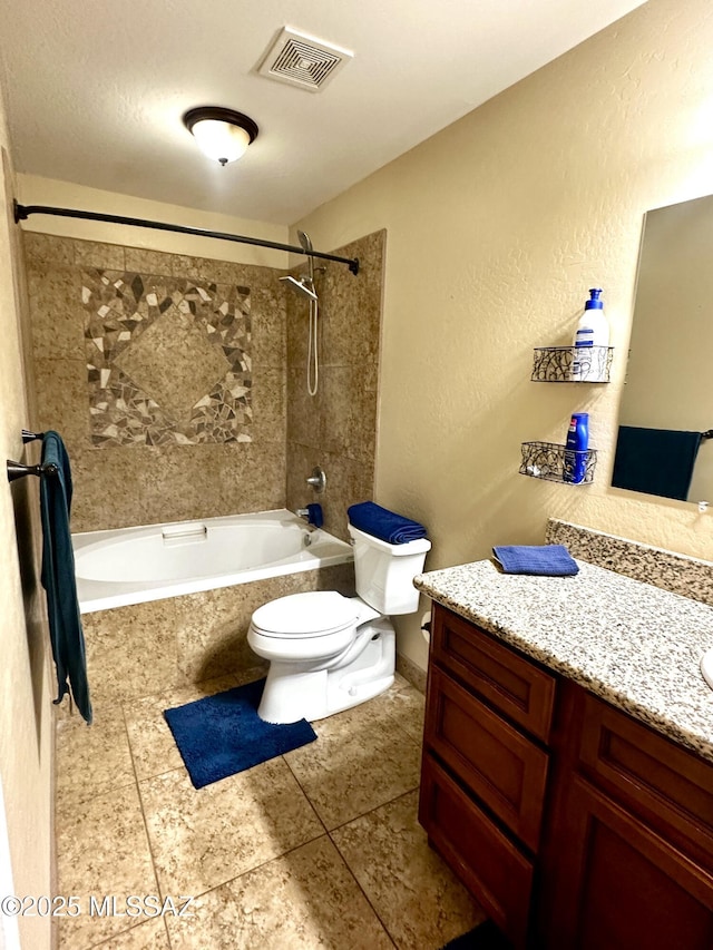 545 W Keisha Ln, Safford, AZ 85546 - bathroom with tiled shower / bath combo, vanity, tile patterned floors, and a textured wall