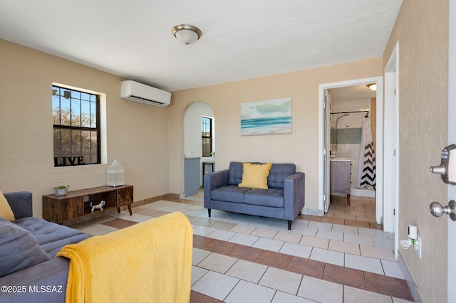 43 W Rillito St, Tucson, AZ 85705 - living area featuring a wall mounted AC, tile patterned flooring, and arched walkways