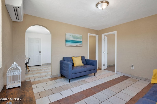 43 W Rillito St, Tucson, AZ 85705 - living area featuring a wall mounted AC, arched walkways, and tile patterned flooring
