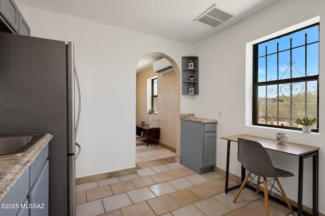 43 W Rillito St, Tucson, AZ 85705 - office area featuring a wall unit AC, arched walkways, healthy amount of natural light, and light tile patterned floors