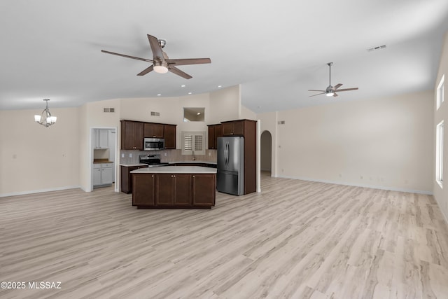 1993 E Desert Lark Pass, Green Valley, AZ 85614 - kitchen featuring appliances with stainless steel finishes, open floor plan, a ceiling fan, a chandelier, and light countertops
