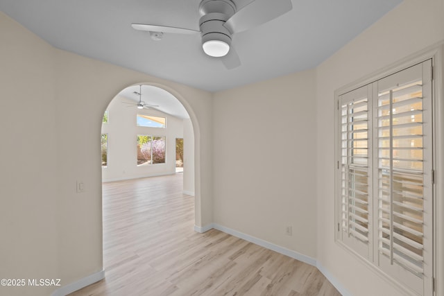 1993 E Desert Lark Pass, Green Valley, AZ 85614 - unfurnished room with ceiling fan, arched walkways, and light wood-style flooring