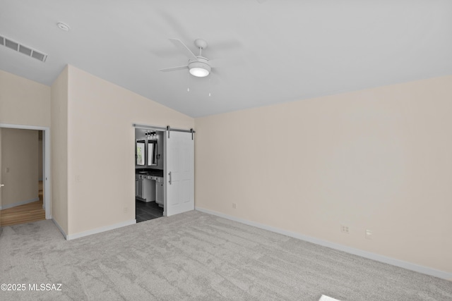 1993 E Desert Lark Pass, Green Valley, AZ 85614 - unfurnished bedroom featuring carpet flooring, vaulted ceiling, ensuite bath, ceiling fan, and a barn door