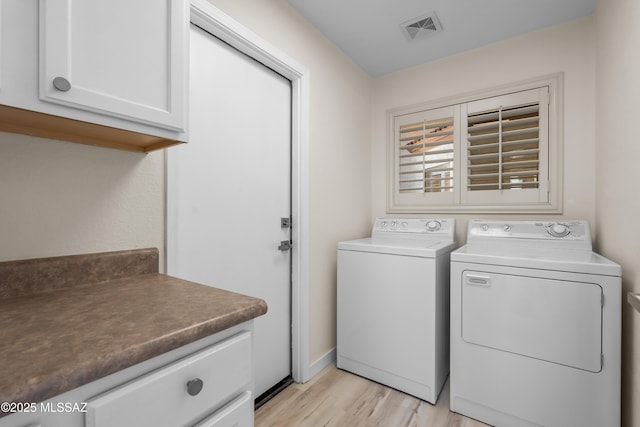 1993 E Desert Lark Pass, Green Valley, AZ 85614 - laundry area with washing machine and dryer, cabinet space, and light wood-style flooring