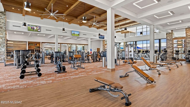 1993 E Desert Lark Pass, Green Valley, AZ 85614 - gym with ceiling fan, a towering ceiling, healthy amount of natural light, wood finished floors, and a wooden ceiling with exposed beams