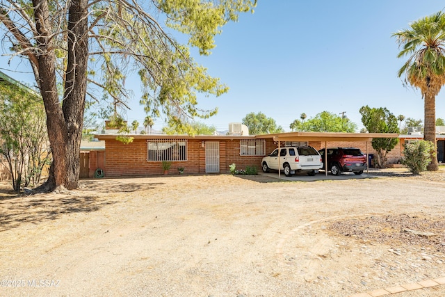 5521 E Camden St, Tucson, AZ 85712 - ranch-style house featuring driveway, brick siding, and a detached carport