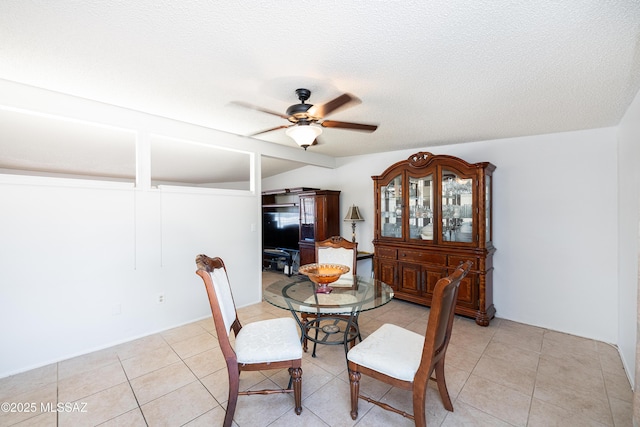 5521 E Camden St, Tucson, AZ 85712 - dining room featuring ceiling fan, light tile patterned flooring, vaulted ceiling, and a textured ceiling