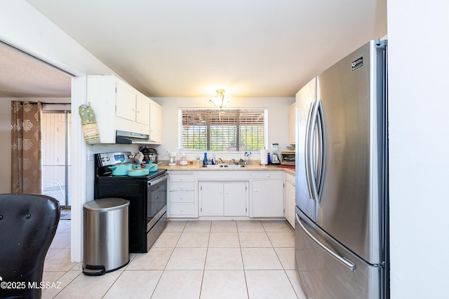 5521 E Camden St, Tucson, AZ 85712 - kitchen featuring stainless steel appliances, under cabinet range hood, light tile patterned flooring, and white cabinetry