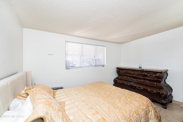 5521 E Camden St, Tucson, AZ 85712 - bedroom with a textured ceiling and light tile patterned flooring