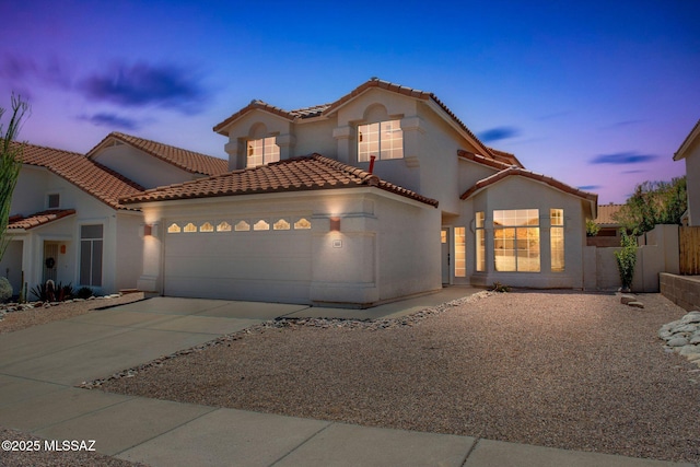 5555 Weeping Rock Dr, Tucson, AZ 85750 - mediterranean / spanish home featuring a garage, driveway, stucco siding, and a tiled roof