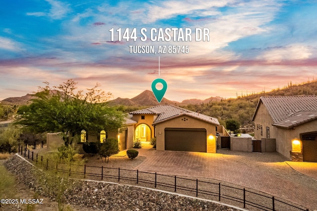 1144 S Castar Dr, Tucson, AZ 85745 - view of front facade featuring an attached garage, driveway, stucco siding, a mountain view, and a tile roof