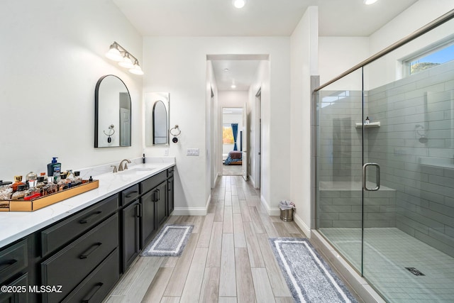 1144 S Castar Dr, Tucson, AZ 85745 - bathroom with vanity, wood finished floors, a shower stall, and recessed lighting