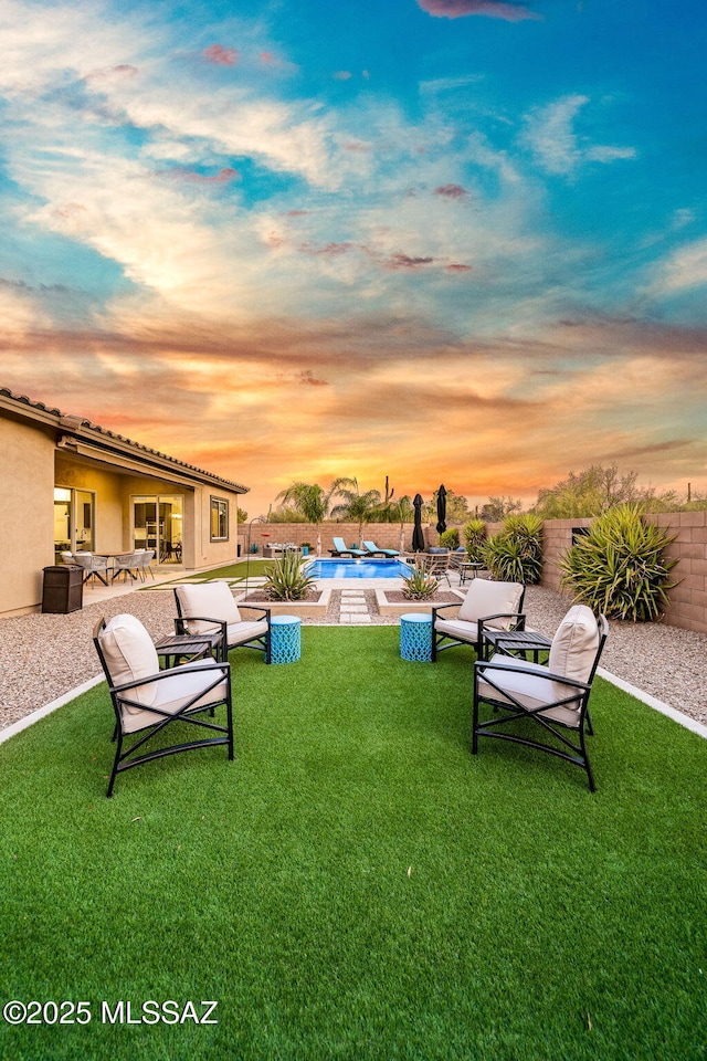 1144 S Castar Dr, Tucson, AZ 85745 - yard at dusk with a patio