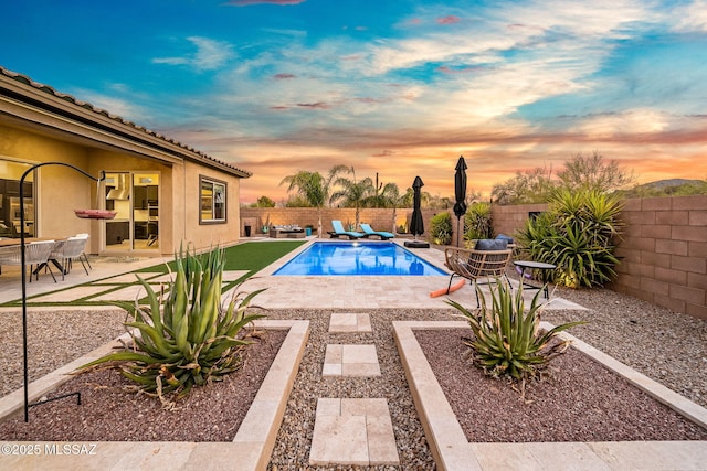 1144 S Castar Dr, Tucson, AZ 85745 - pool at dusk with a fenced backyard and a patio area