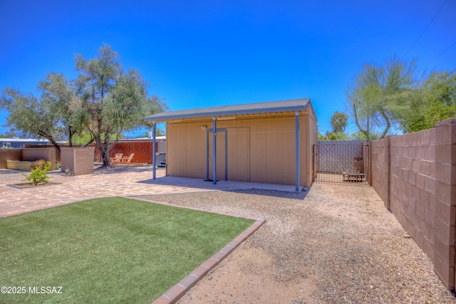 626 S Kellond Pl, Tucson, AZ 85710 - fenced backyard featuring a patio area and an outdoor structure