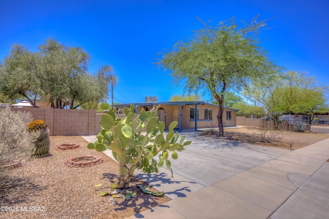 626 S Kellond Pl, Tucson, AZ 85710 - view of front of property with a fire pit, a patio, a fenced backyard, and stucco siding