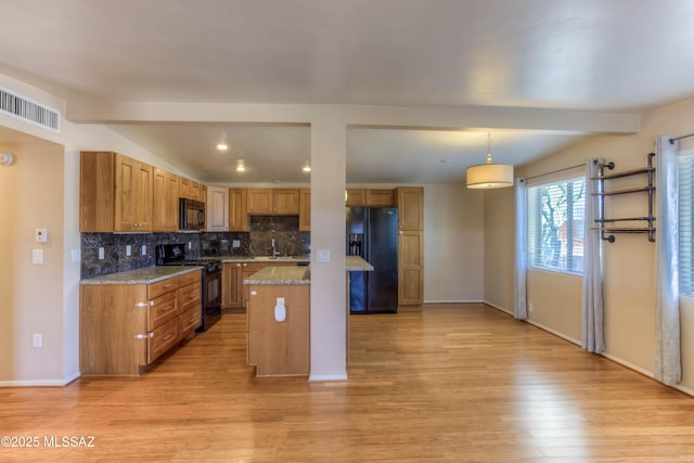 626 S Kellond Pl, Tucson, AZ 85710 - kitchen with black appliances, light wood-type flooring, backsplash, light stone countertops, and beam ceiling
