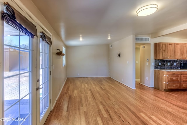 626 S Kellond Pl, Tucson, AZ 85710 - unfurnished living room featuring light wood finished floors and baseboards