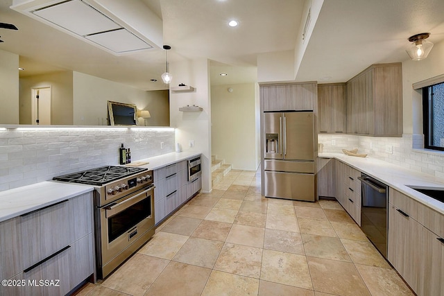 6530 N Finisterra, Tucson, AZ 85750 - kitchen with high quality appliances, decorative backsplash, light countertops, modern cabinets, and light brown cabinets