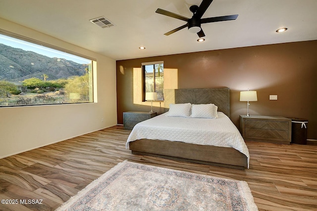 6530 N Finisterra, Tucson, AZ 85750 - bedroom featuring wood finished floors, recessed lighting, a mountain view, and a ceiling fan
