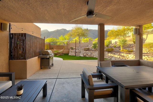 6530 N Finisterra, Tucson, AZ 85750 - fenced backyard with a mountain view, grilling area, a patio, ceiling fan, and outdoor dining space