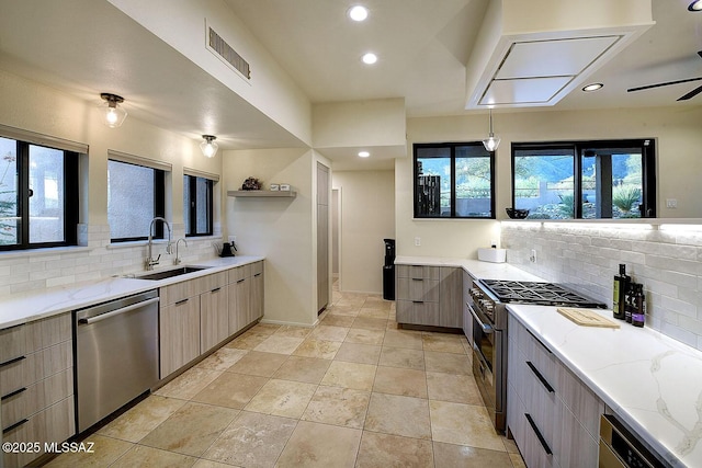 6530 N Finisterra, Tucson, AZ 85750 - kitchen with appliances with stainless steel finishes, tasteful backsplash, light stone countertops, modern cabinets, and recessed lighting